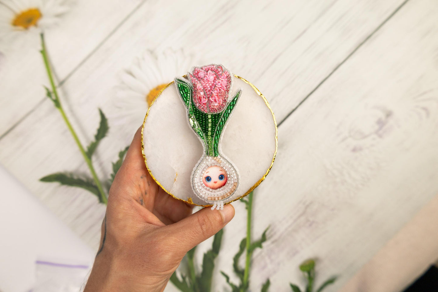 a person holding a flower in their hand