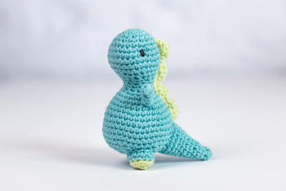 a crocheted toy of a blue dinosaur