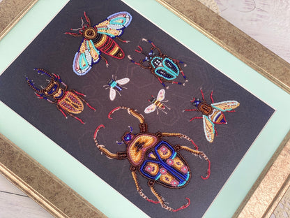 a framed artwork depicting a variety of colorful and intricate insects, including a large dragonfly, a group of bees, and several other types of bugs.