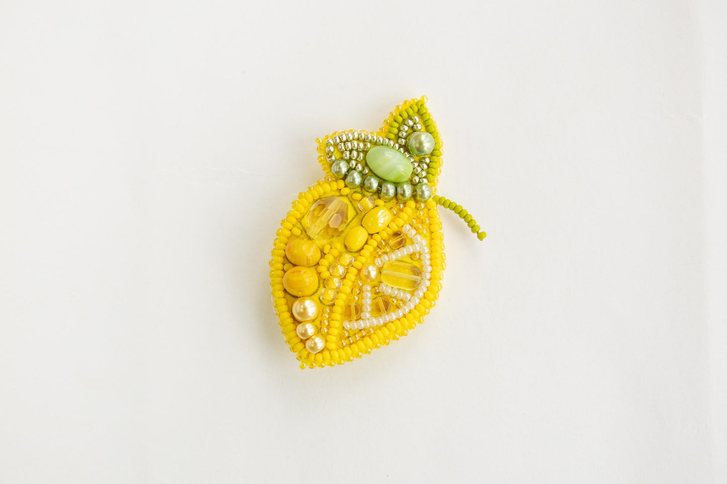 a beaded brooch with a lemon on it