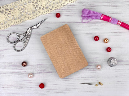 a pair of scissors, a book, and other craft supplies on a table