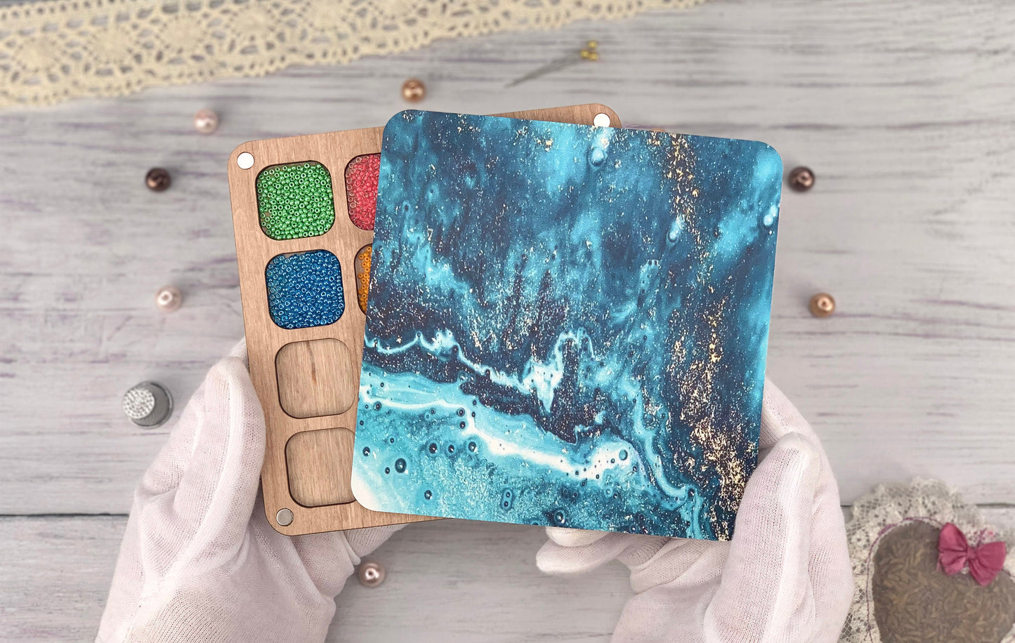 a person holding a wooden board with a painting on it