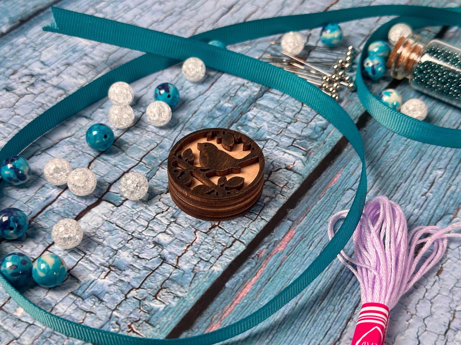 a necklace with beads and a wooden box on a table