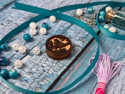 a necklace with beads and a wooden box on a table