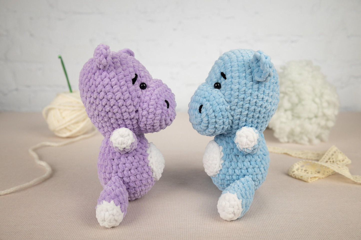 two crocheted stuffed animals sitting next to each other