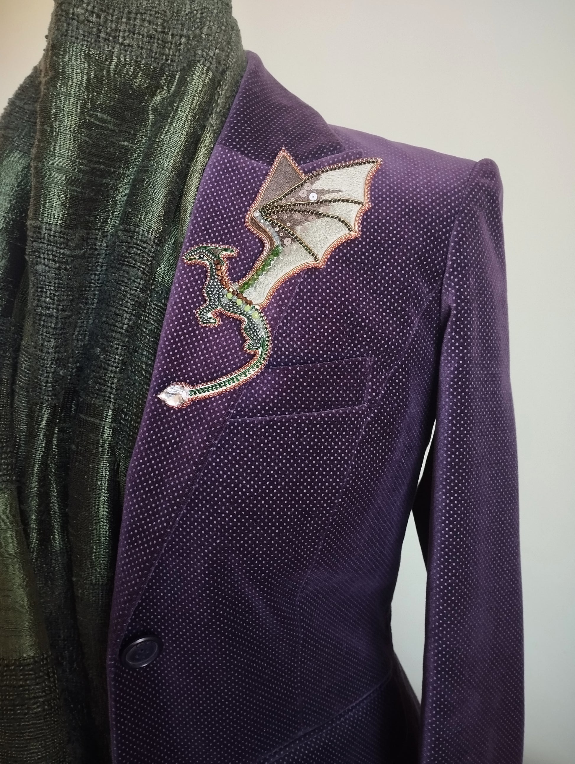 A purple jacket with a dragon embroidered patch on the left side.