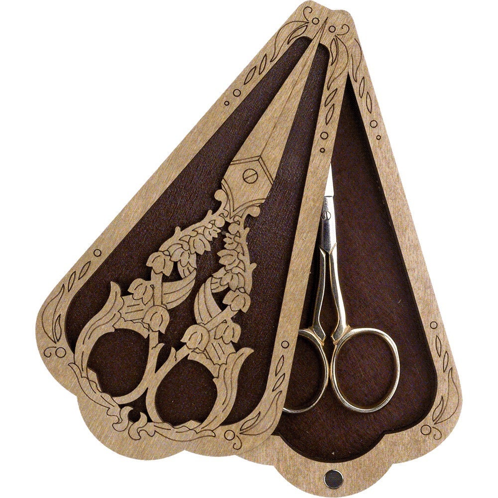 a pair of scissors sitting inside of a wooden case