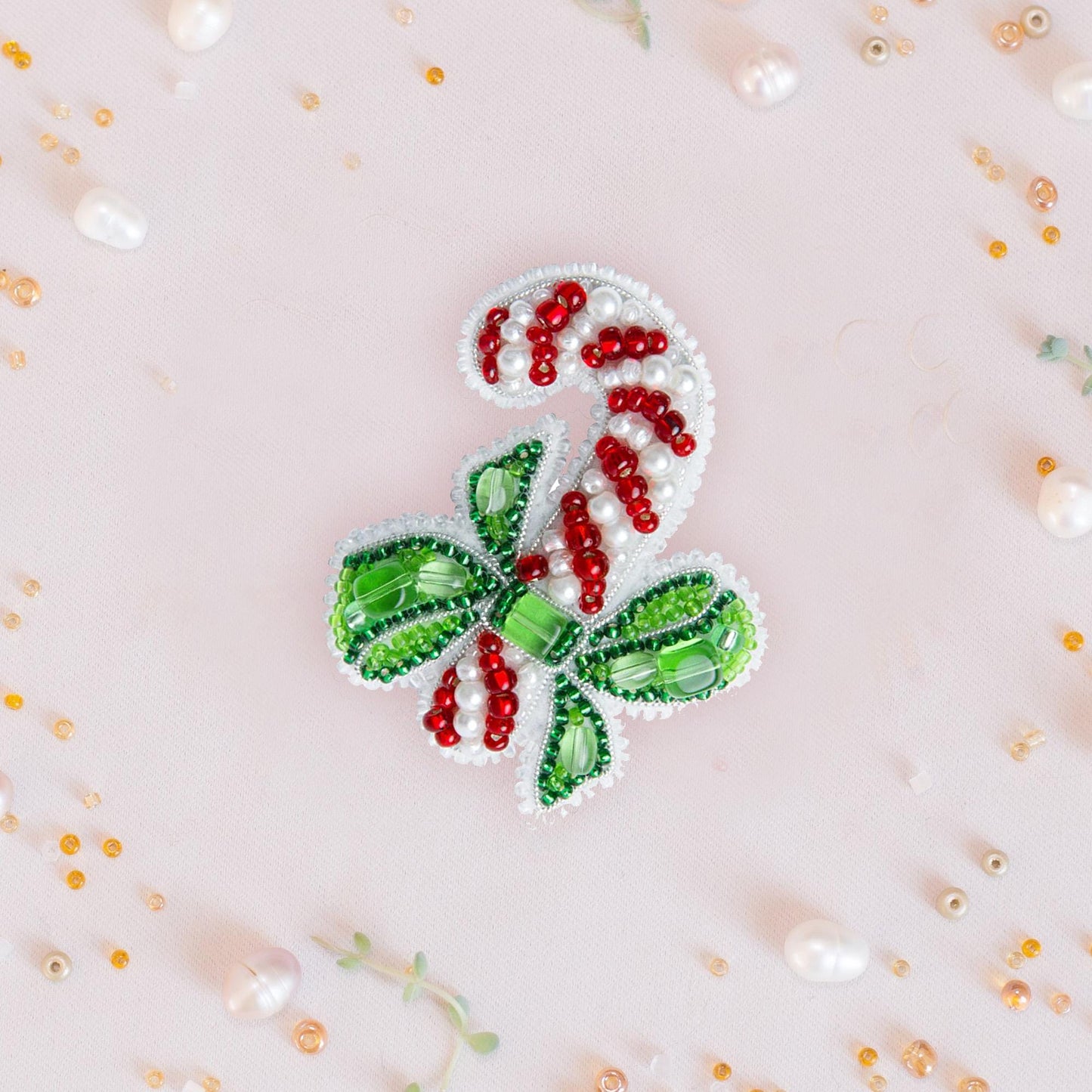 a close up of a candy cane brooch