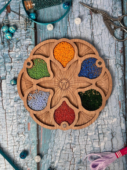 a wooden plate with a bunch of beads on it