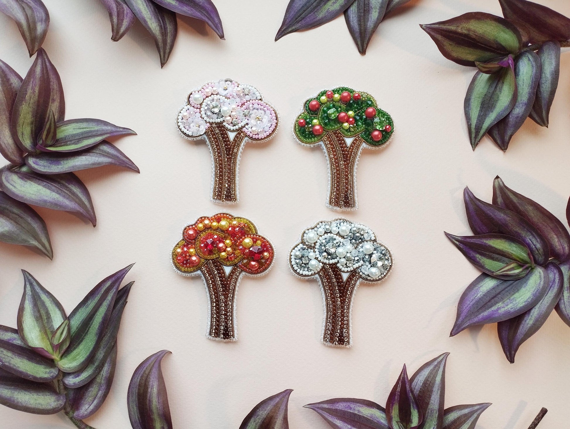 a group of four brooches sitting on top of a table