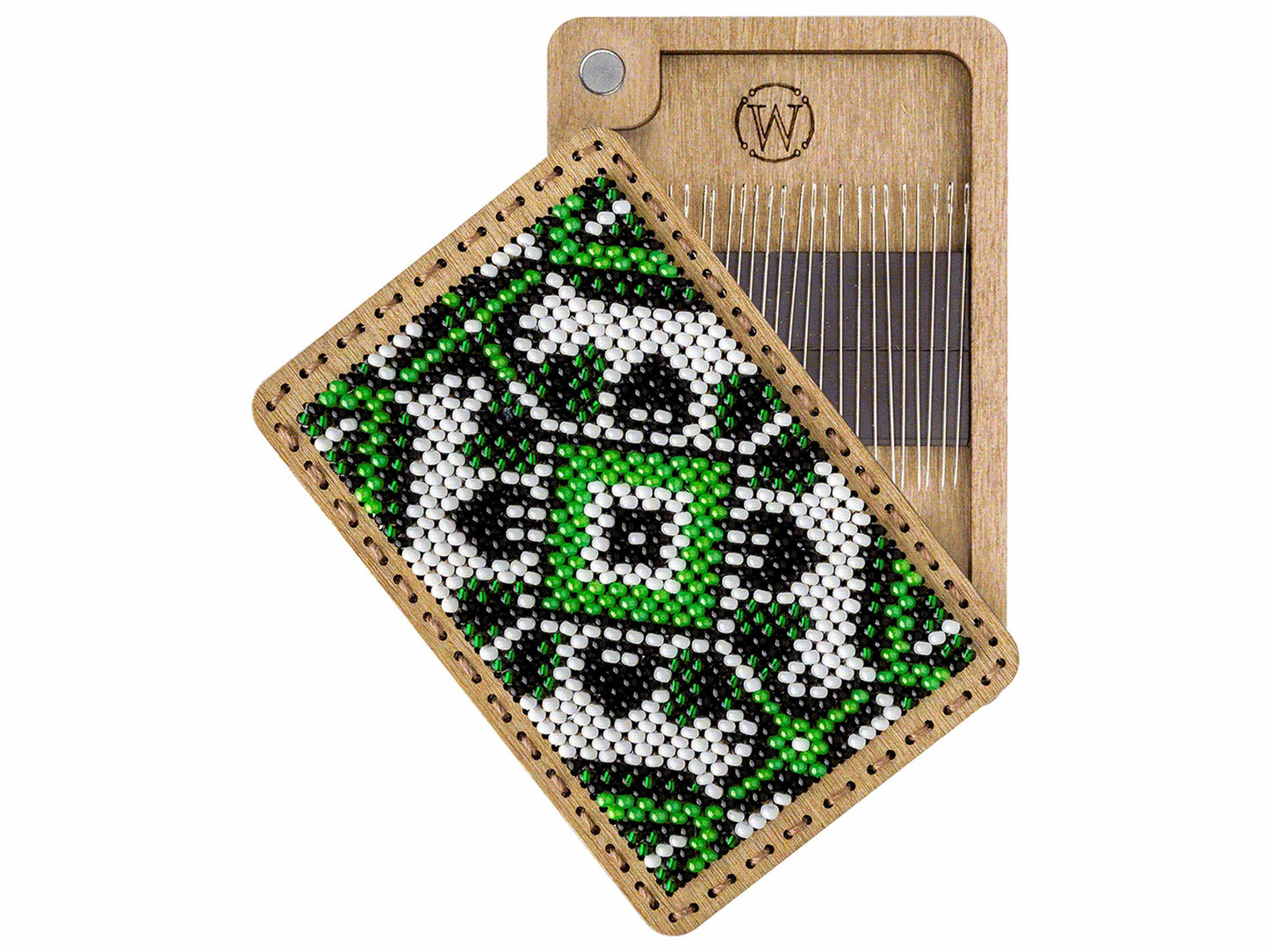 a wooden comb with a green and white beaded design on it