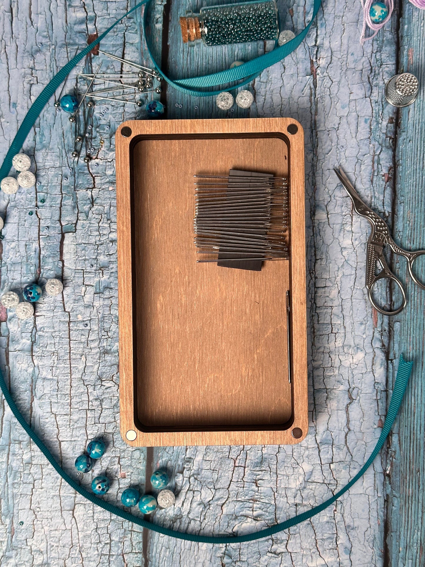 a wooden box with some scissors on a table