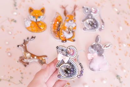 a person is holding a brooch in their hand