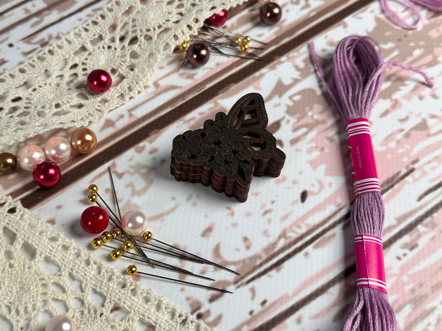 a pair of scissors next to a piece of lace