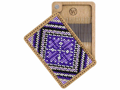 a piece of wood with a beaded pattern on it