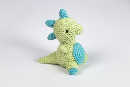 a crocheted stuffed animal sitting on a white surface