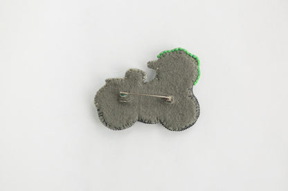 a brooch with a pin in the shape of a flower