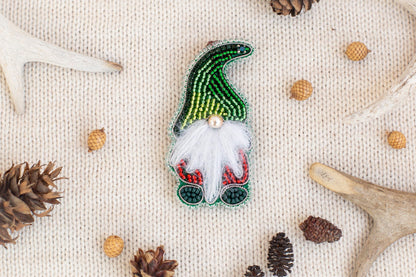 a Christmas ornament with a gnome design, surrounded by various natural elements such as pine cones, antlers, and acorns.
