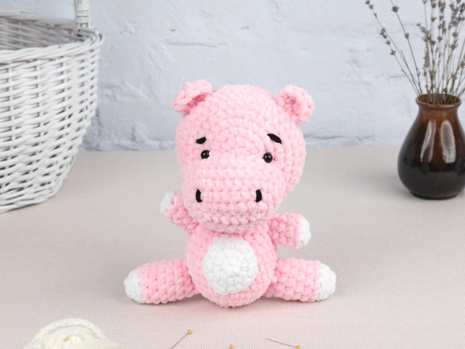 a pink crocheted stuffed animal sitting on a table