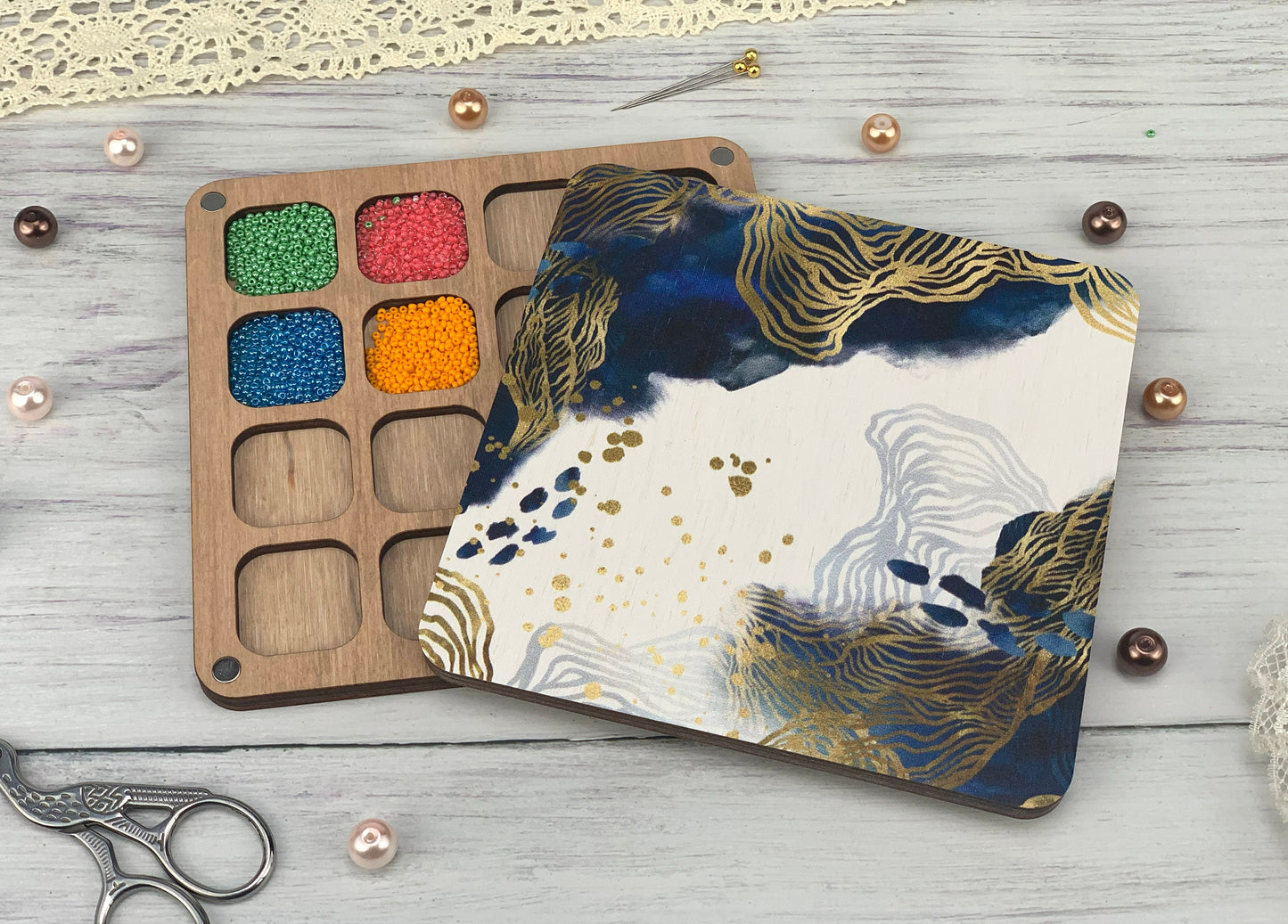 a wooden tray with paint and a pair of scissors