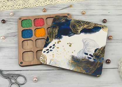 a wooden tray with paint and a pair of scissors