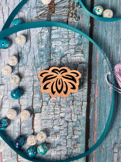 a piece of wood with a flower on it
