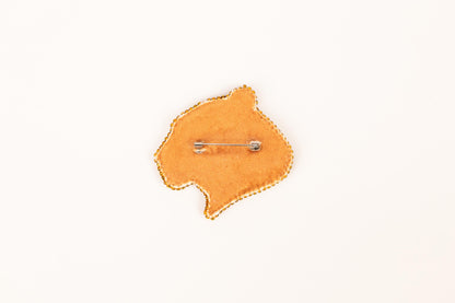 a pin with a map of africa on it