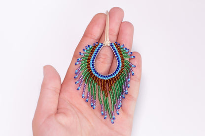 a hand holding a colorful beaded necklace