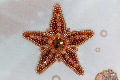 a starfish adorned with various colorful beads and gemstones, creating a visually striking and intricate piece of jewelry.