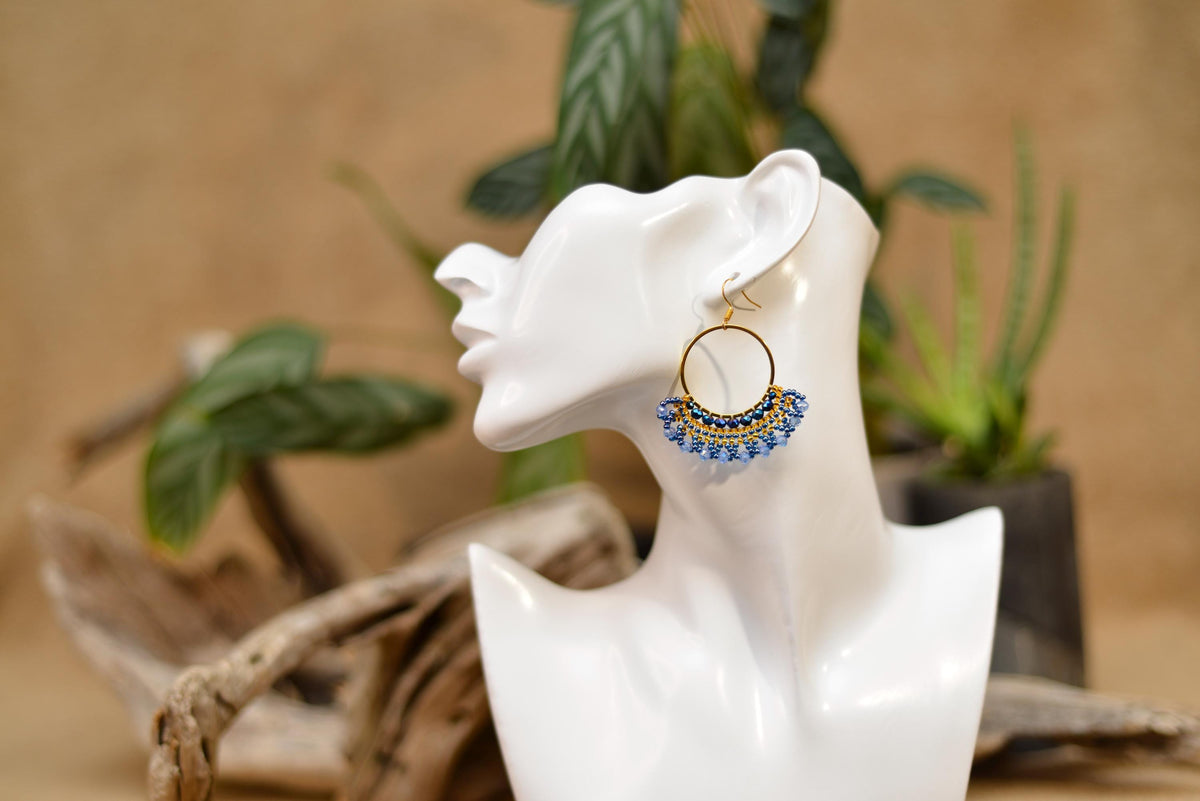 a close up of a pair of earrings on a table