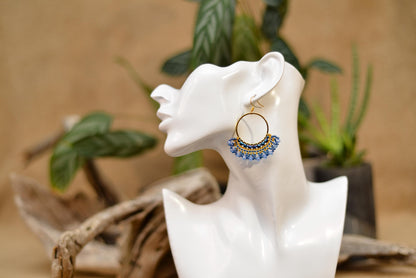 a close up of a pair of earrings on a table
