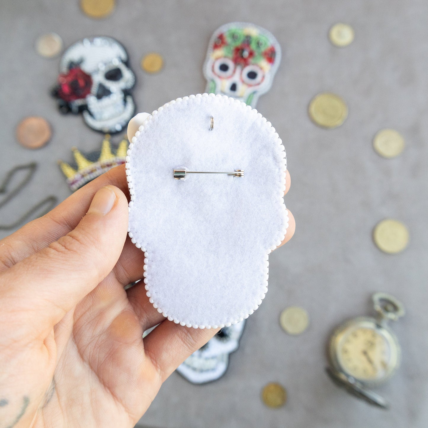 a person holding a white piece of paper with a skull on it