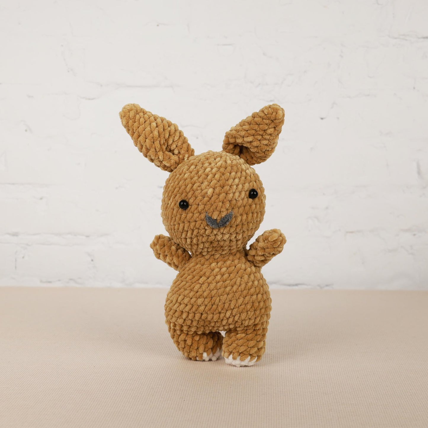 a small brown stuffed animal sitting on top of a table
