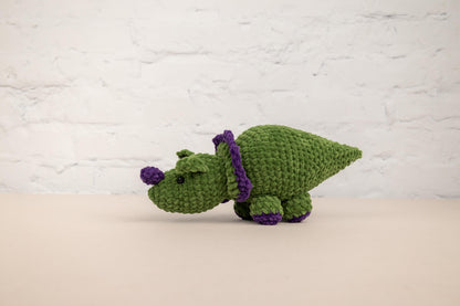 a crocheted green and purple stuffed animal
