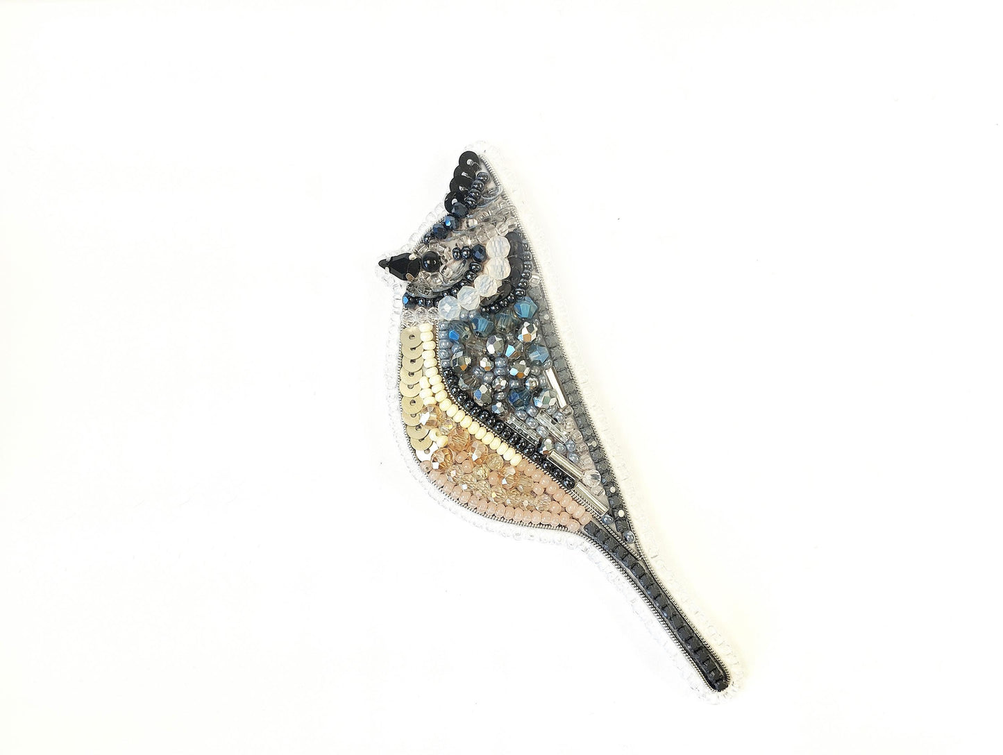 a bird made out of beads on a white background
