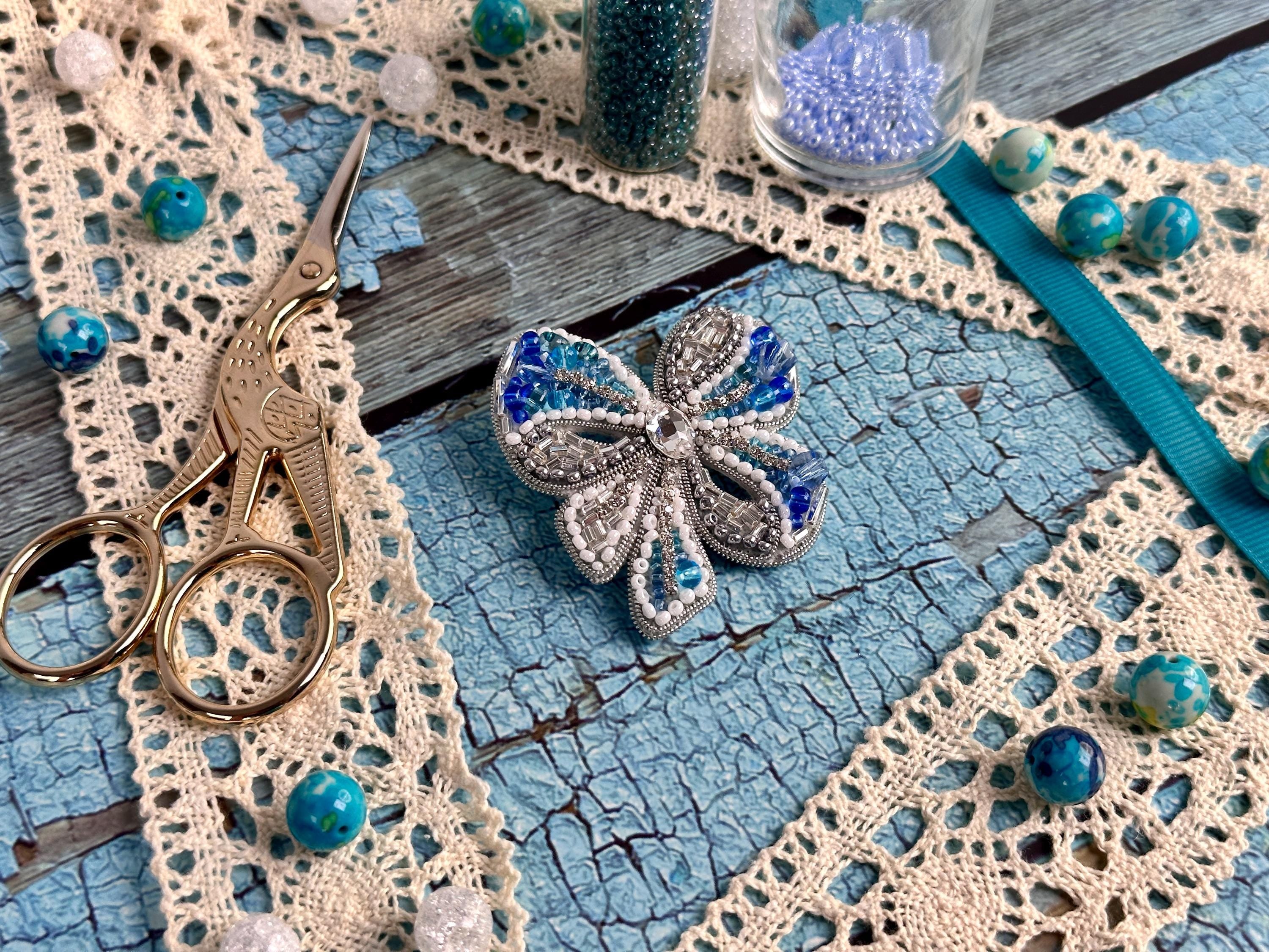 a pair of scissors sitting on top of a piece of lace