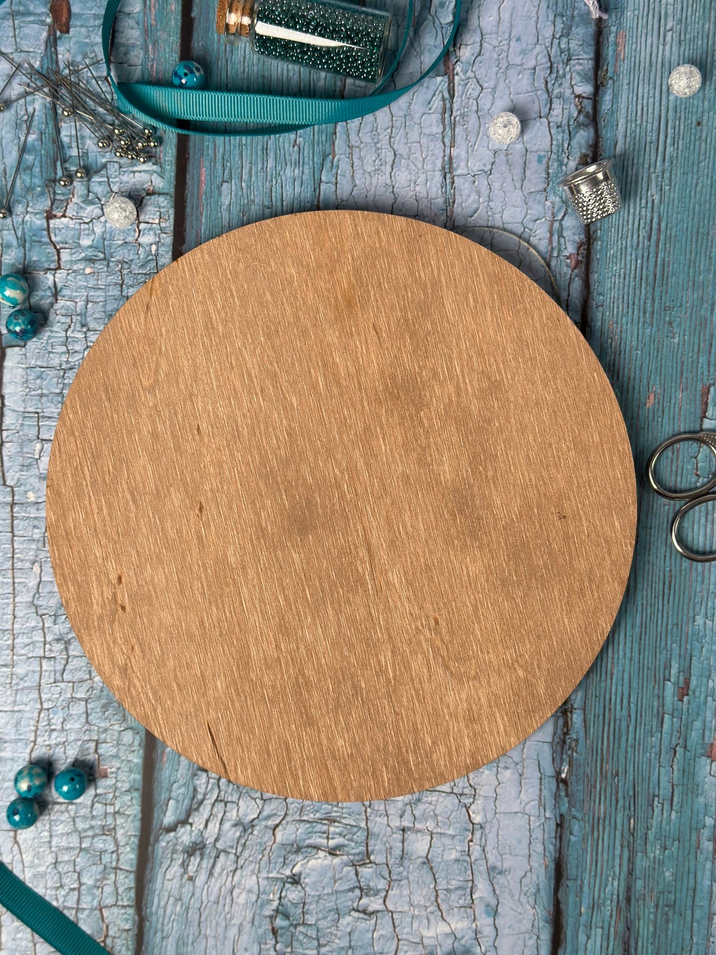 a round wooden board sitting on top of a wooden table