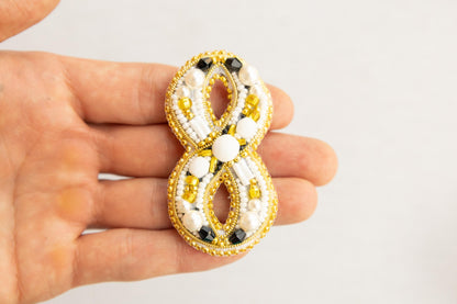 a person is holding a brooch in their hand