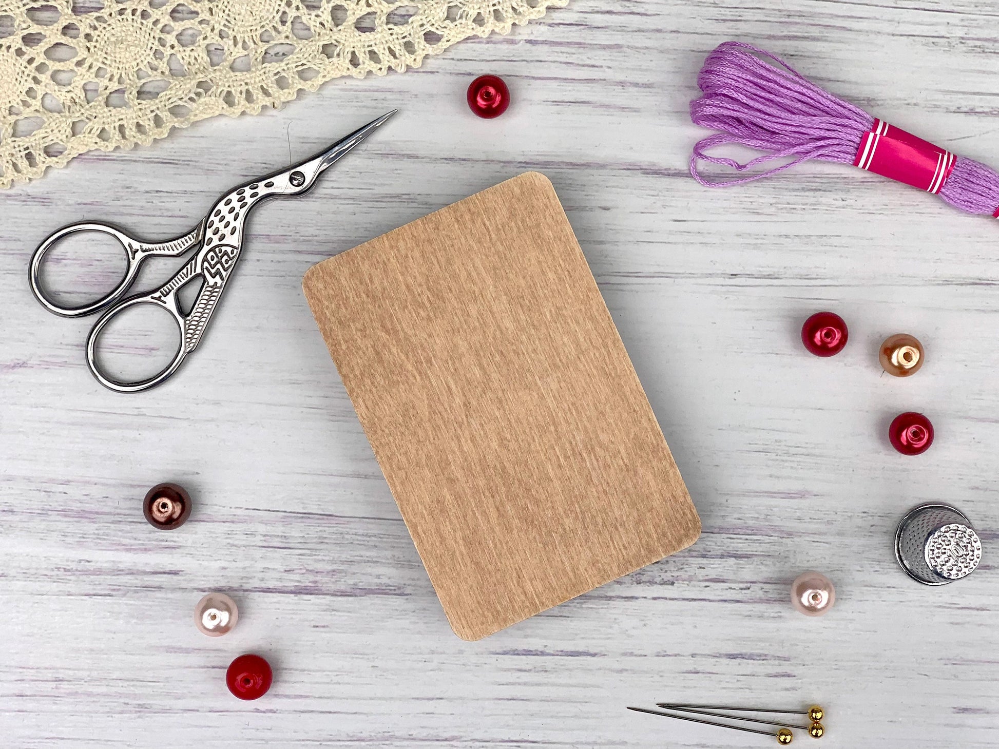 a craft kit with scissors, thread, buttons and a notebook