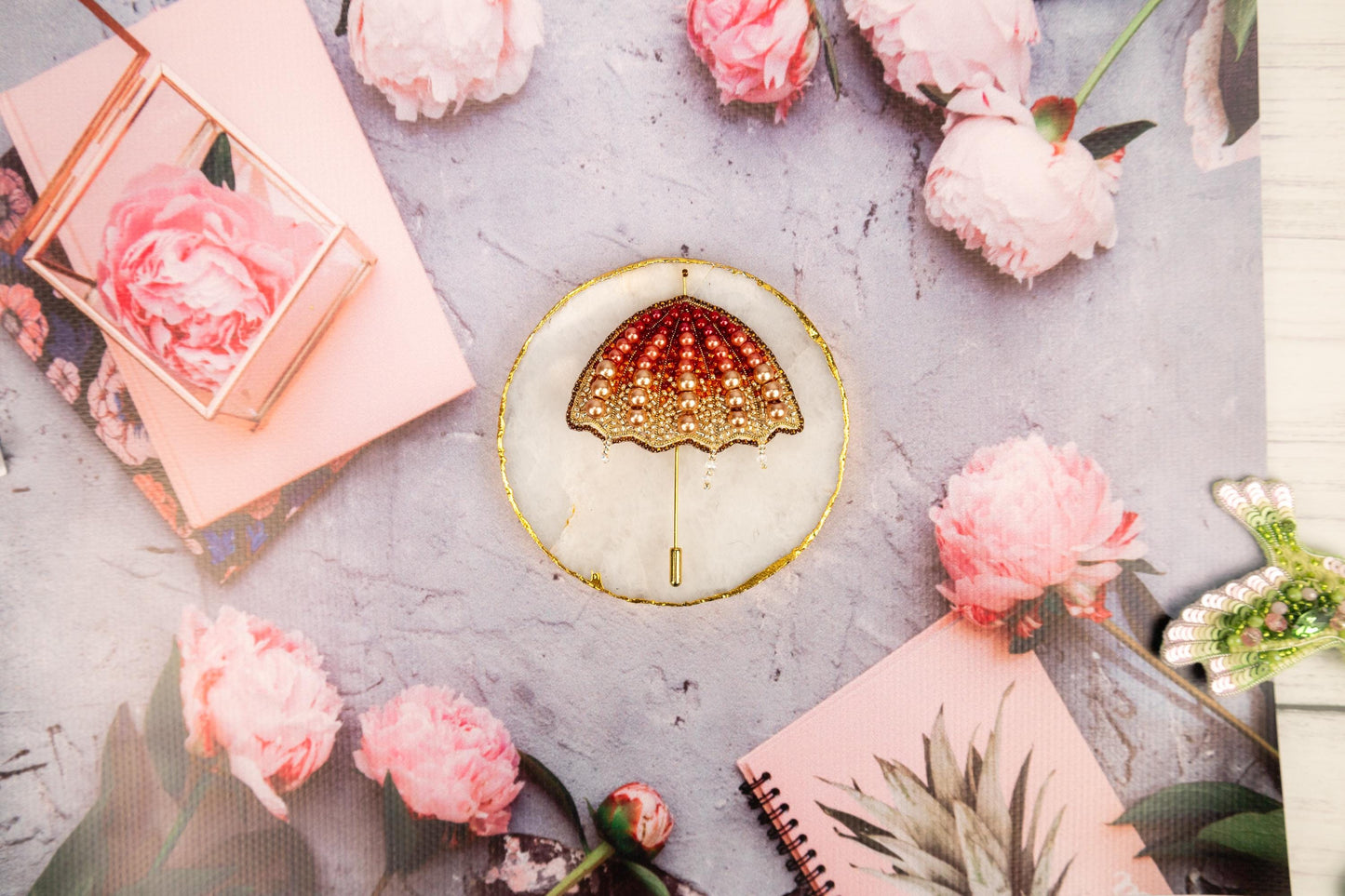 a table topped with pink flowers and a gold plate