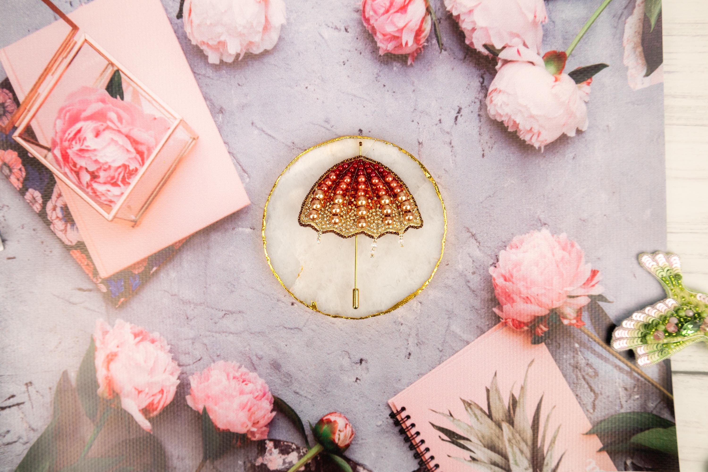 a table topped with pink flowers and a gold plate