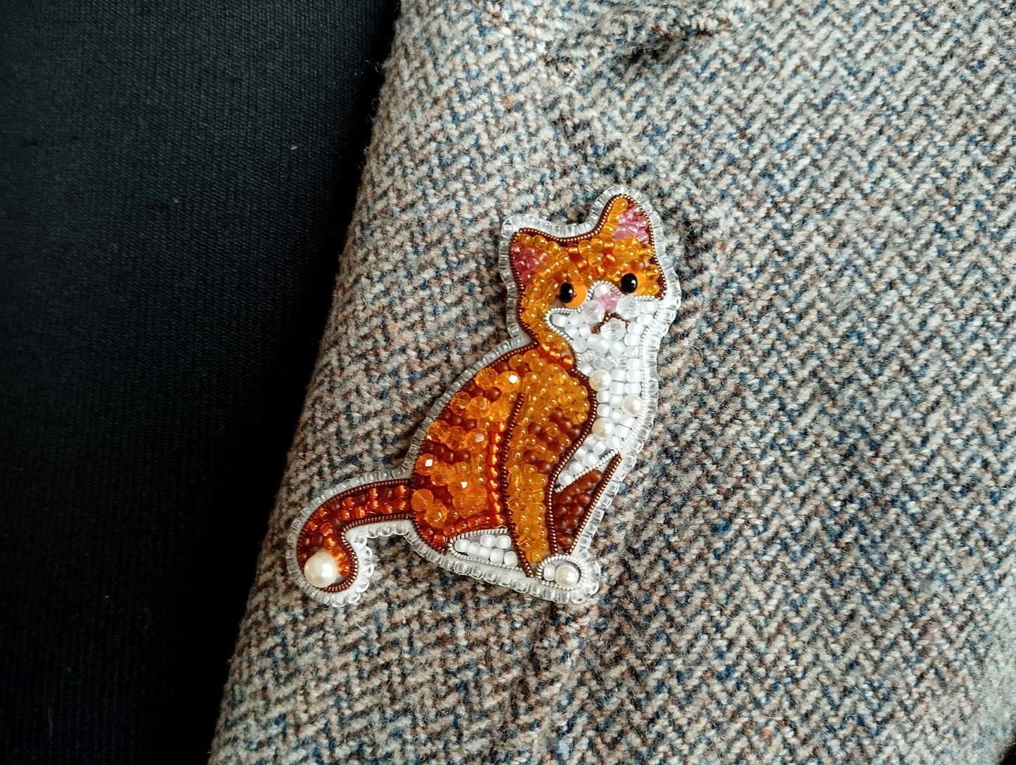 a close-up view of a cat embroidered on a fabric, with a detailed and intricate design.