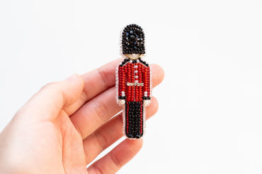 a person holding a beaded toy in their hand