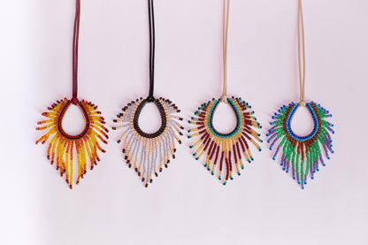 a group of three necklaces hanging on a wall