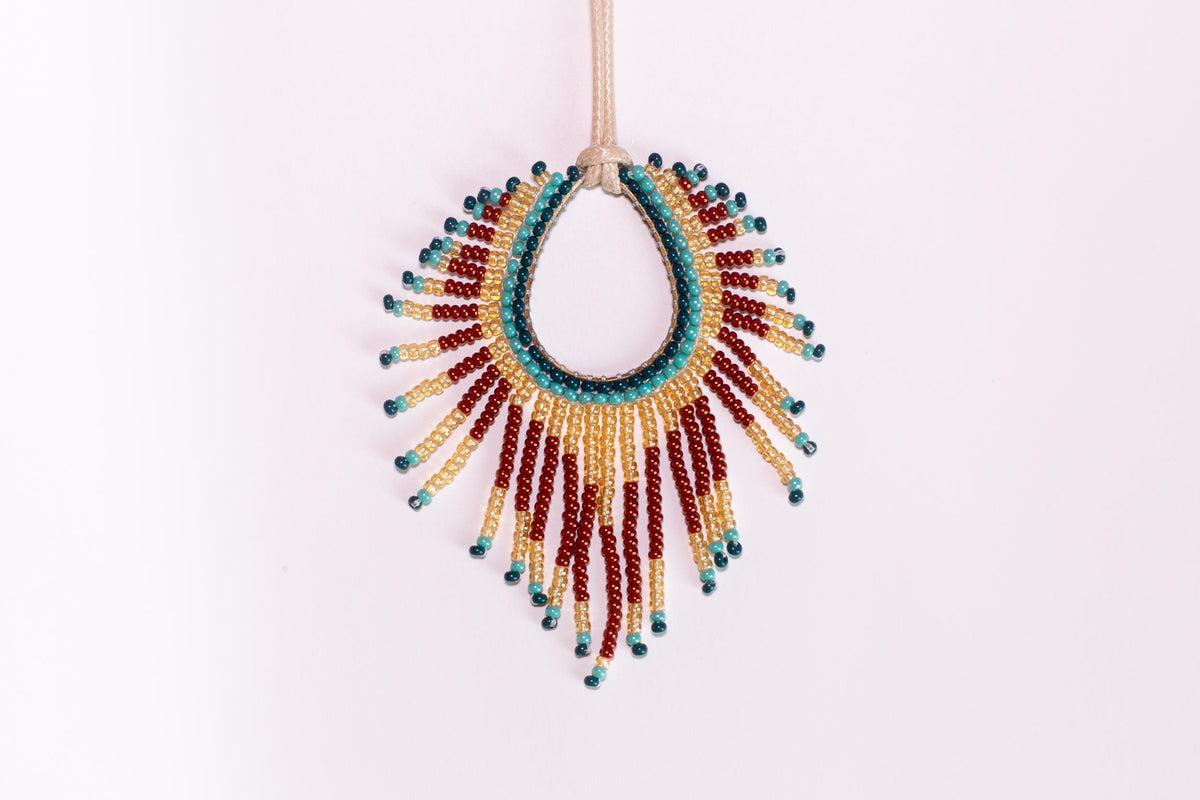 a beaded necklace hanging on a string