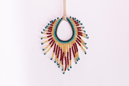 a beaded necklace hanging on a string