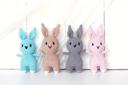 a group of crocheted bunnies sitting next to each other