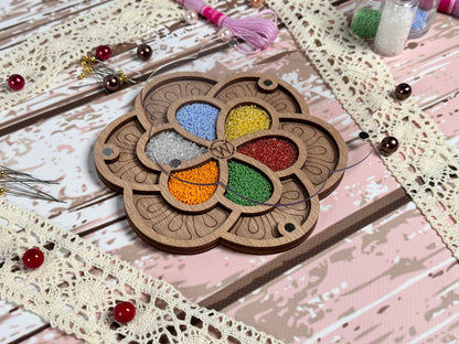 a wooden brooch with a flower design on it