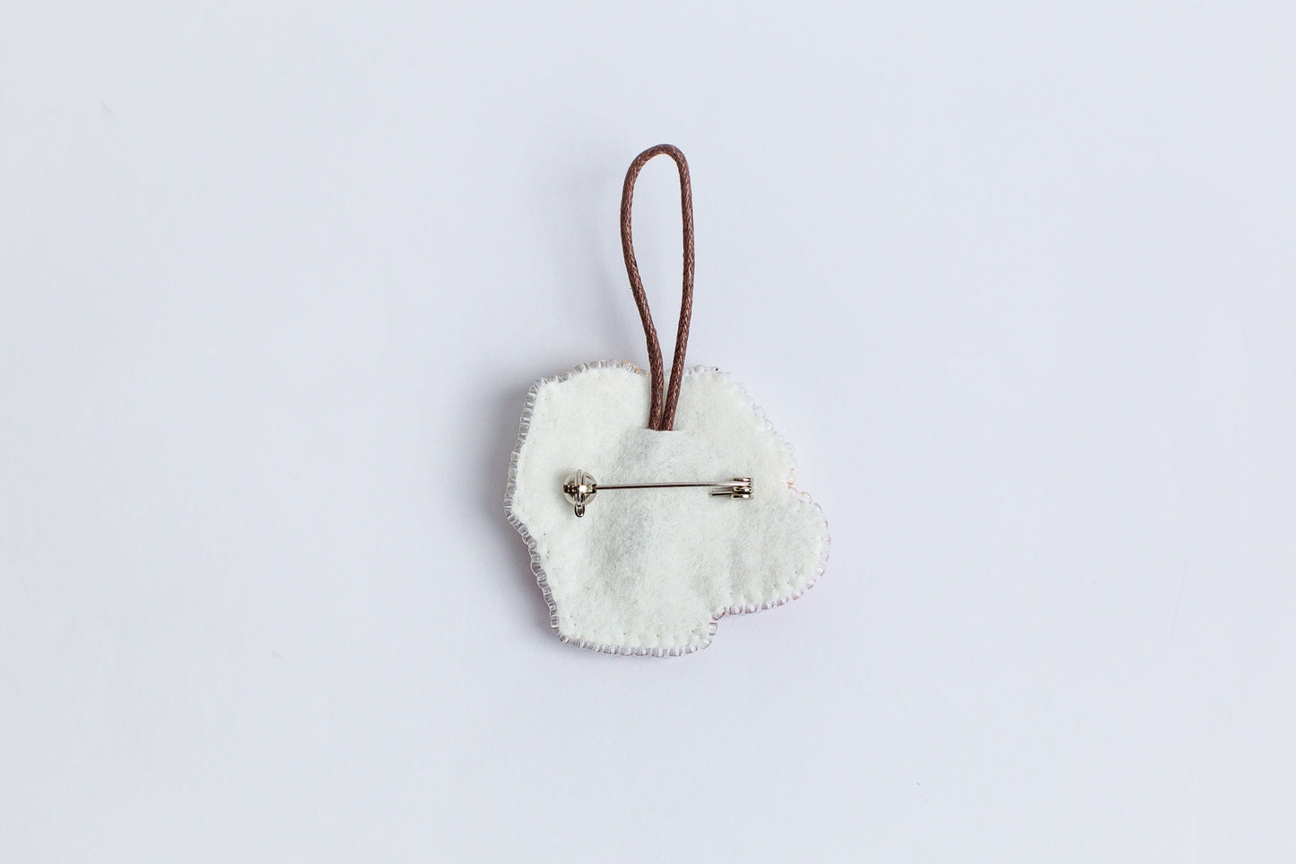 a white heart shaped ornament hanging from a cord
