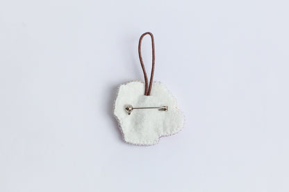 a white heart shaped ornament hanging from a cord